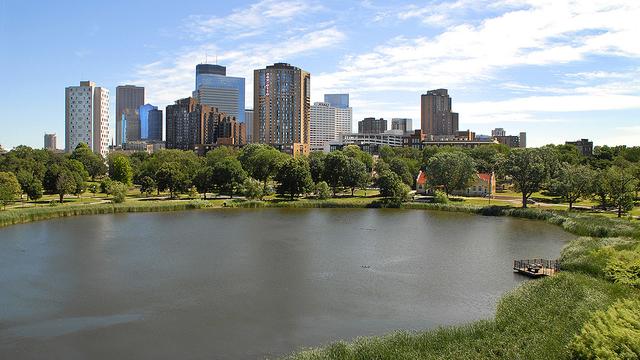 A small lake with Minneapolis high-rise buildings in the background