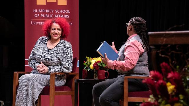 Nikole Hannah-Jones and Kyndell Harkness sit on stage at Northrop