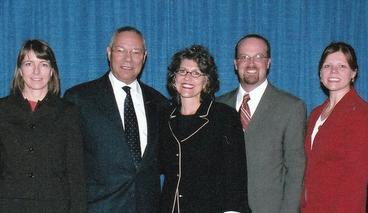 Group shot of Colin Powell with four Humphrey School staff members