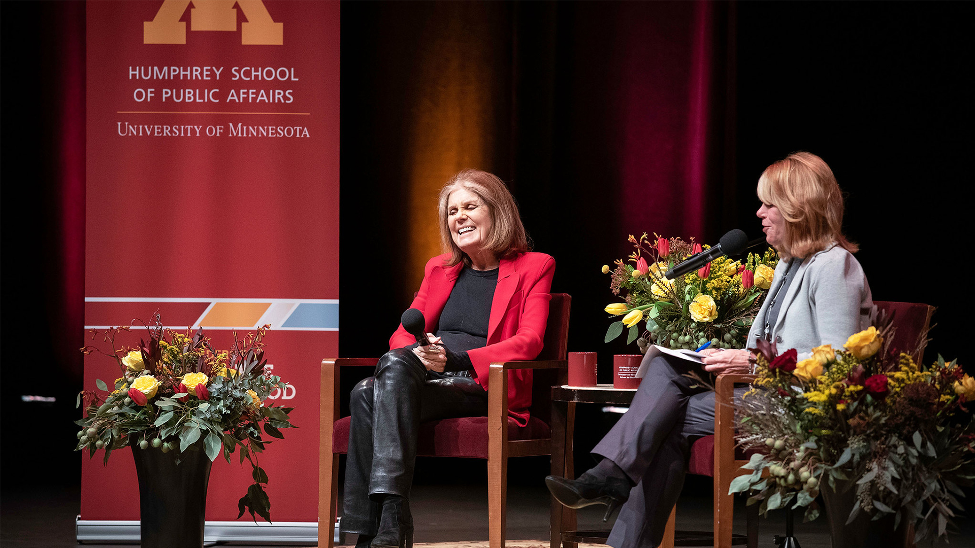 Gloria Steinem and Kerri Miller in conversation onstage with the Humphrey School logo in the background