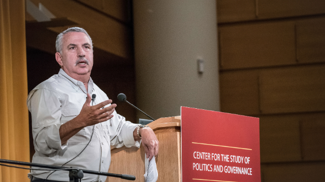 Tom Friedman speaks at a podium with the CSPG logo