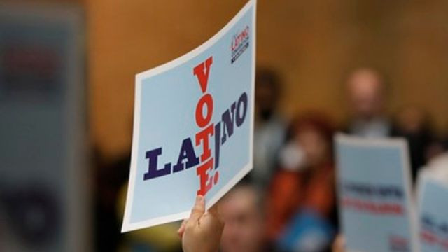 Someone holding a sign that reads "Latino Vote"