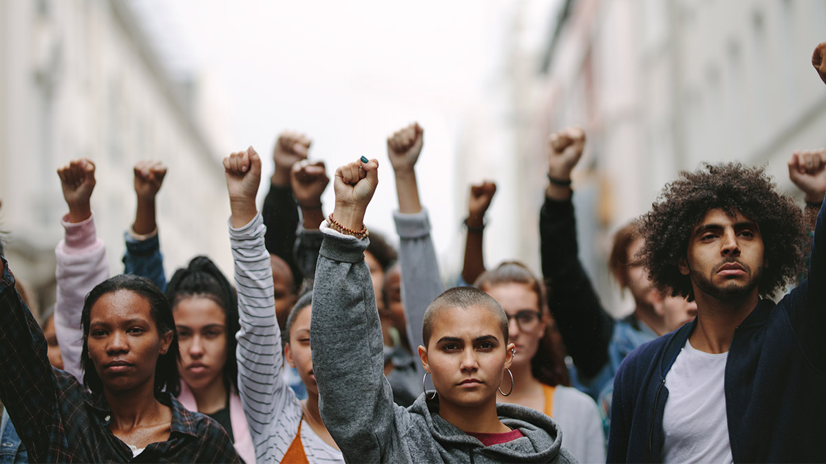 people holding up their fists at a protest