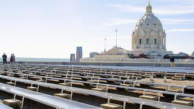 Solar panels on a building with the Minnesota State Capitol in the background
