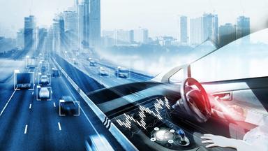Futuristic image of a person driving a car outside of a city