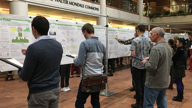 Poster session in the commons area of the Humphrey School