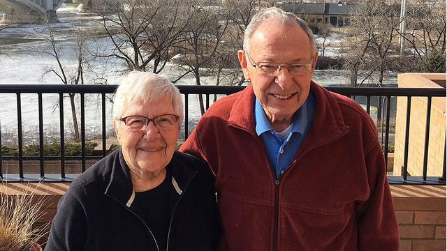 Arvonne and Don Fraser standing outside with the Mississippi River in the background
