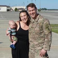 Andrew Jaunich with his wife and young child