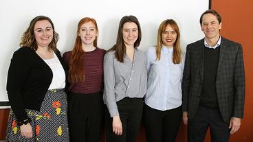 Group shot of four human rights students with UN official Todd Howland