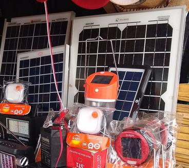 Solar panels and lanterns for sale at a market in Sibanga, Kenya