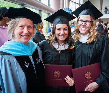 Mary Curtin with two graduates at 2019 commencement